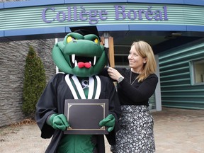 Mélanie Dufresne, Timmins campus director at Collège Boréal, places a mortarboard on the college mascot (worn by Angèle Larue) as the college prepares to recognize students graduating this year through a virtual and a drive-through ceremony next month. 

RICHA BHOSALE/The Daily Press