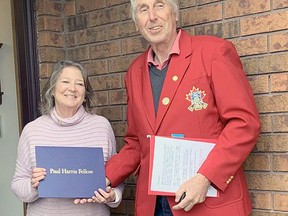 Members of the Rotary Club of Norfolk Sunrise surprised Cathy Harrop of Simcoe with a Paul Harris Fellowship. Doing the honours was fellow Rotarian Peter Wheatley of Simcoe. Submitted/Rotary Club of Norfolk Sunrise