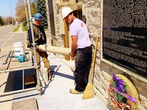 Employees of Robertson Restoration in Brantford cart away deteriorated stonework from the Norfolk War Memorial on Norfolk Street North in Simcoe. The $77,700 repair job now underway will arrest deterioration of the entrance facing onto Norfolk Street North. At left is Thomas Klak while at right is Hayden Robertson. Monte Sonnenberg/Postmedia Network