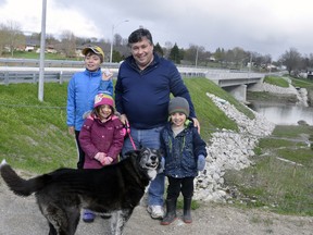 West Perth Coun. Jeff Marshall, pictured with son Lewis, 10; twins Maria and Nick, 4, and 12-year-old dog Lightning pose on the newly-completed trail west of the Henry Street bridge April 15. The trail, along with the tunnel on the bridge's east side, have proven a popular addition to the municipality's trail system. ANDY BADER/MITCHELL ADVOCATE