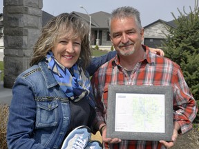 Jackie and Brad Pierce, of Mitchell, hold up a framed map of Mitchell signed by West Perth Mayor Walter McKenzie congratulating them on walking every street in town. Avid walkers, the couple, on the advice of a friend, embarked to complete the walk - an estimated 44-kilometres - which they completed last month. ANDY BADER/MITCHELL ADVOCATE