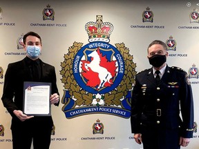 Chatham-Kent police Const. Max Bossence, left, receives a board citation from Chief Gary Conn on April 20. Bossence was recognized for his efforts in saving the life of a Wallaceburg stabbing victim last month.