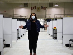 Jaime Fletcher, manager of the Southwestern Public Health OCVID-19 vaccination task force, stands in front of the 36 vaccination stations on the arena surface at the St. Thomas-Elgin Memorial Arena. Dr. Joyce Lock, the region's top doctor, said the Pfizer vaccine is effective against the variants of the COVID-19 virus behind at least 18 of the area's 72 ongoing cases. (Kathleen Saylors/Postmedia Network)