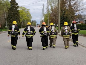 During a former Mothers Day Run, local firefighters are seen tailing the runners to ensure their safety. Submitted