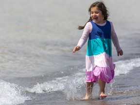 Dorothy Andrighetti, 6, runs along the edge of Lake Erie on the main beach in Port Stanley on April 18. Melissa Andrighetti said Dorothy, "doesn't feel the cold, she's always been like that," about her romping in the cold water. Mike Hensen/Postmedia Network