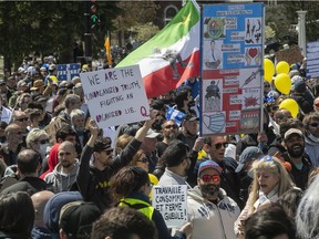 Protesters show their displeasure at the government public-health measures during a protest near the Olympic Stadium on Saturday May 1, 2021 during the COVID-19 pandemic.