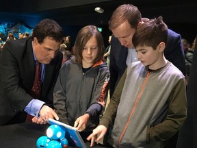 Nickel Belt MP Marc Serre and Sudbury MP Paul Lefebvre interact with students during a pre-pandemic photo op.