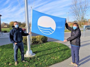 Trent Port Marina officials hoist a Blue Flag awarded by Swim Drink Fish group for efforts to protect the environment.