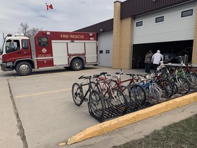 People stopping by the Portage Fire Hall to check out some of the bikes available through the Firefighters Burn Fund Auction. (Aaron Wilgosh/Postmedia)