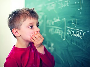 Little boy aged 5 in math class overwhelmed by the math formula. (METRO CREATIVE SERVICES)