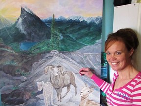 Local artist, Juli-Ann McKenzie putting finishing touches on her mountain goats in her Scaling the Heights painting.
(Submitted)