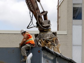 Workers are involved in the early stages of the demolition at the former St. Vincent de Paul Hospital site on Thursday afternoon. (RONALD ZAJAC/The Recorder and Times)