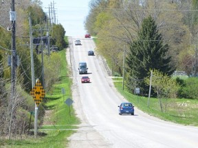 Vehicles travel along Grey Road 17B between Somers Street and Highway 6 in Georgian Bluffs on Thursday, May 6, 2021.