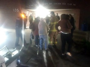 Firefighters and police assist residents in returning to their units at the Golden Age Towers early this morning.

Submitted Photo