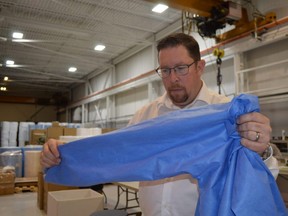 Windsor-based Harbour Technologies is expanding is personal protective equipment manufacturing operations to Chatham-Kent. Co-owner David Glover is seen here with one of the PPE gowns the company manufacturers.