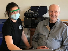 Grey Gables resident Hugh Olston and Recreation Aide Briana Wilson recently tested a new laptop purchased with a $500 donation from Bruce Power that gave over 30 Long-Term Care homes in Bruce, Grey and Huron counties $500 to boost their activity program budgets. [Supplied]