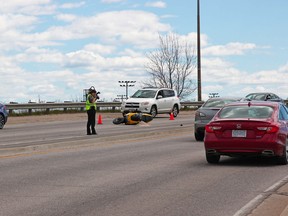 North Bay Police Service Forensic Identification Services members investigate the scene of a collision on the Lakeshore Drive overpass, Wednesday afternoon, involving a motorcycle. Michael Lee/The Nugget