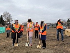 (From left to right, front to back) Heartland Housing Foundation CEO Nancy Simmonds, Robin Hood Association executive director Ann Marie LePan, HHF board chair and Fort Sask. councillor Deanna Lennox, family members of the late Muriel Ross Abdurahman, Fort Saskatchewan Mayor Gale Katchur, and Fort councillor and HHF board member Brian Kelly pose during the groundbreaking ceremony at the new affordable housing site in Fort Saskatchewan. Photo Supplied