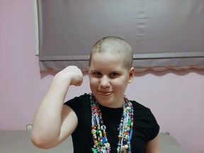 Dakota Scully flexes with her bravery beads. Dakota is scheduled to undergo Pial Synangiosis surgery June 30 unless COVID-19 pushes it back. Scully's mother, Kara, said this is the best chance for longevity for her 11-year-old daughter.
Submitted