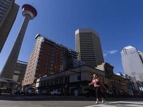 A masked pedestrian crosses the Centre Street in downtown Calgary on Friday, April 16, 2021. PHOTO BY AZIN GHAFFARI/POSTMEDIA