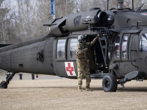 A member of the Wisconsin National Guard stands next to a UH-60 Blackhawk helicopter during a medical evacuation rehearsal during Exercise Maple Resolve at CFB Wainwright on April 29, 2021. PHOTO BY CPL RACHAEL ALLEN /Canadian Forces