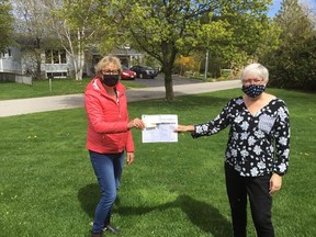 For the fourth year in a row, Tiverton’s Shelly Parker (left) is the top fundraiser in the Huron Shores Hospice virtual hike from home May 8. She presented a $6,164 cheque and ledge sheets to to hospice board co-chair Cheryl Cottrill.