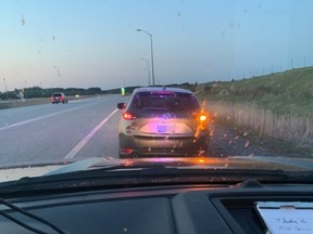 OPP officers stop a vehicle on Highway 69 on Sunday for stunt driving.