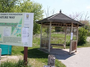 A notice advising the Suncor Nature Way will be closing May 31 is affixed to a map at the Sarnia trail's entrance. A stormwater management pond there is being dredged at a cost of $880,000. (The Kula/The Observer)