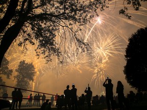 Watchers in Centennial Park hold up cell phones to record the finale of a fireworks display Friday July 14, 2017 in Trenton, Ont. Tim Miller/Belleville Intelligencer/Postmedia Network