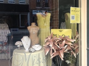 Downtown District BIA is reminding residents that they can window shop at downtown retailers such as Miss Priss which have a yellow card displaying "We're Open" and can in most cases buy directly from the store without purchasing the item beforehand online under curbside shopping.