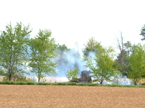 Stratford and Perth East firefighters responded to a grass fire in a farmer’s field at the west end of Stratford Sunday night. Pictured, smoke could still be seen billowing from the field Monday morning. Galen Simmons/The Beacon Herald/Postmedia Network