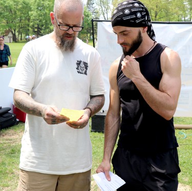 Luke Haynes speaks with Frasier Keany after Keany is ticketed by Sault Ste. Marie Police Service for organizing an anti-lockdown protest at Bellevue Park in Sault Ste. Marie, Ont., on Saturday, May 23, 2021. (BRIAN KELLY/THE SAULT STAR/POSTMEDIA NETWORK)
