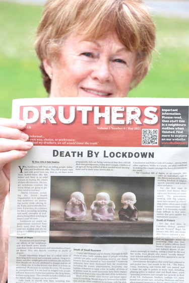 Anti-lockdown protest at Bellevue Park in Sault Ste. Marie, Ont., on Saturday, May 23, 2021. A woman holds a copy of the Druthers newspaper. (BRIAN KELLY/THE SAULT STAR/POSTMEDIA NETWORK)