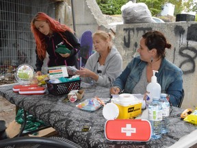 In this file photo, STOP (Sudbury Temporary Overdose Prevention) Society volunteers Carla Ocampo, left, Kathy Savage and Karla Ghartey, a registered nurse and one of the group’s founding members, arrange supplies at the overdose prevention site off Lloyd Street. Jim Moodie/Sudbury Star