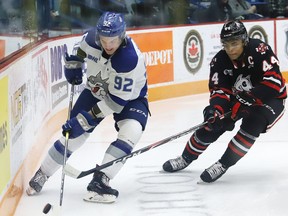 Blake Murray, left, of the Sudbury Wolves, and Akil Thomas, of the Niagara IceDogs, chase after the puck during OHL action at the Sudbury Community Arena in Sudbury, Ont. on Friday November 8, 2019.