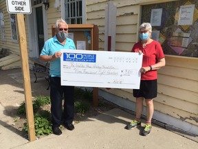 Bill Pike (L) of 100PeopleWhoShare Bruce County presents a cheque for $9,800 to Sylvia Leigh, of The Walker House Heritage Foundation. SUBMITTED