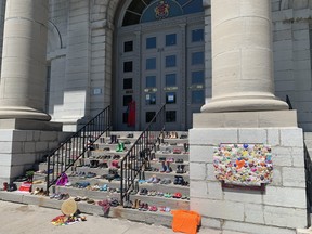 Pairs of shoes were placed on the steps of Kingston City Hall on May 31, 2021, to honour the 215 children whose remains were discovered at a former residential school in Kamloops, B.C., it was announced on May 27, 2021.