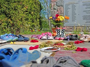 Shoes are seen, Monday afternoon, at the residential school monument in the Duchesnay community of Nipissing First Nation to honour the 215 children whose remains were recently found on the site of the Kamloops Indian Residential School in B.C. Michael Lee/The Nugget