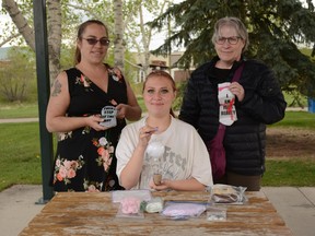 Mother Jennifer Brown (from left to right), daughter Kia Brown, and grandmother Cheryl Chapman present some of the crafts and socks that they sold to raise $1,820 for the Airdrie and District Hospice Society for the Hike for Hospice this year.