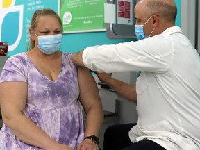 Kimberlee Newman received a Moderna vaccine from Whitecourt Rexall pharmacist Daniel Sander recently.