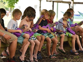 Children play ukuleles at Kenesserie Camp near Ridgetown in 2019. The camp has decided to cancel its summer overnight program for children this year. (Handout/Postmedia Network)