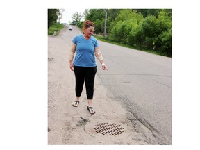 Michelle Newburn of Laurentian Valley returned to the scene of her motorcycle collision on Forced Road to see the drop at the side of the road near a manhole cover, a spot she hit before losing control of the bike and going over the handlebars, causing life-altering injuries. She is hoping to warn other motorists of the potential hazard and hoping the spot will be fixed or a warning sign or pylon placed at the location.