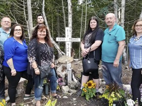 In this 2019 photo, the families of Traves Atchison and Jana Watson stand at a roadside memorial they created shortly after the couple died in a head-on crash south of Tobermory four years ago. From the left, starting at the back: Travis's father, Steve Atchison, Jana's twin brother, James Watson, Jana's grandmother Holly Watson, Traves' sister Julie Atchison, his mother Joanne Atchison, Jana's mother, Maureen Stinson, Jana's grandfather Joe Watson, and Traves' sister Andria Atchison-Gillard. Scott Dunn/The Owen Sound Sun Times/Postmedia Network