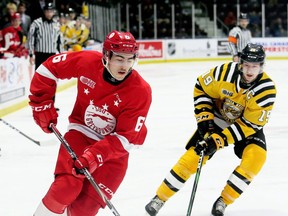 Soo Greyhounds' rearguard Jacob Holmes (left) tries to skate past Sarnia Sting's Ryan McGregor in 2019 OHL action in Sarnia, Ont. 
Mark Malone/Postmedia Network