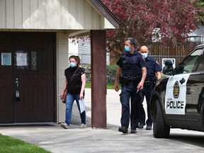 Calgary police officers were with an Alberta Health Services official who was attaching closed to the public signs to doors at Fairview Baptist Church on Monday, May 17, 2021. Church Pastor Tim Stephens was arrested on Sunday after repeatedly failing to comply with public health restrictions.