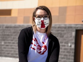 Rachelle Bell (shown in this picture) who is the Indigenous liaison for St. John Paul II. Bell’s mask was created by students in the school’s technology class.