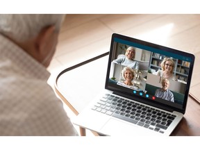 Senior man makes videocall talking with friends by videoconference application