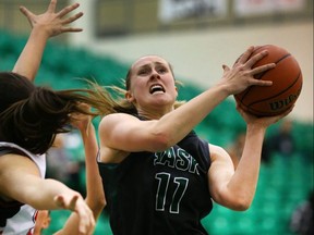 Saskatchewan Huskies' Laura Dally works a shot around a Winnipeg Wesmen defender in Saskatoon, Sask., on Nov. 14, 2014. (Gord Waldner/The StarPhoenix/Postmedia Network)