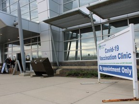 People outside the Suncor Community Leisure Centre at MacDonald Island Park, where a COVID-19 vaccination site is held, on Wednesday, May 26, 2021. Vincent McDermott/Fort McMurray Today/Postmedia Network