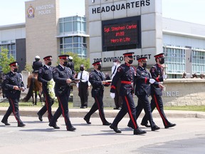 Kingston Police colour guard, Chief Antje McNeely (front, centre), and Const. Trevor Bethune (rear, left) march from Kingston Police Headquarters to St. Mary's Cemetery and Sgt. Stephen Carter's final resting place on Friday, May 21, 2021.